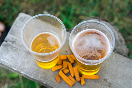 Beer in a plastic Cup. Alcohol at the picnic.