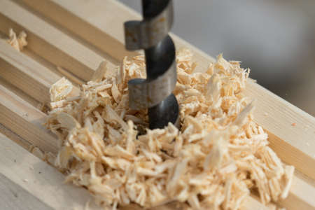 The man drilling the wood. Place for your text..の写真素材