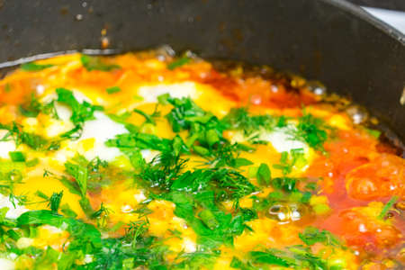 Cook shakshuka on a gas stove in a frying panの写真素材