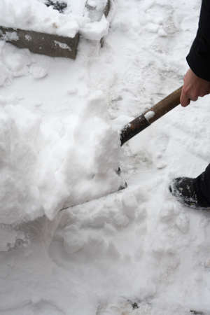 clean snow shovel. Cleaning the sidewalk of snow.の写真素材