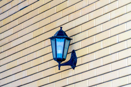 Street lamp hanging on a brick wall. Street lamp hanging on a brick wall.の写真素材