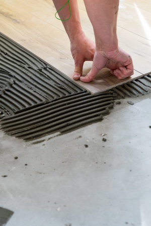 Laying tiles on the floor with a special glue. Laying tiles on the floor with a special glue.