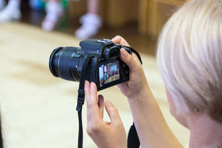 A woman takes pictures with a SLR camera. A woman takes pictures with a SLR camera.の写真素材