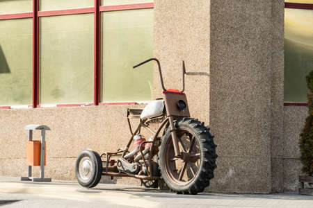 An old motorcycle stands against the wall. An old motorcycle stands against the wall.の写真素材