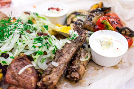 Large dishes with a variety of products cooked on the grill.の写真素材