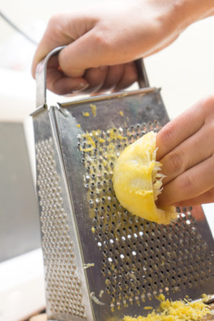 Removing the zest from the lemon. an ingredient for delicious dishes. Removing the zest from the...