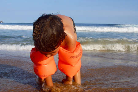 boy playing sand at the bay of San Agustinillo in the southern state of Oaxaca in Mexico, Latinamericaの写真素材