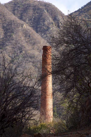 abandoned chimeney of a factory  in the town of Alamos, in the northern state of Sonora, Mexico, Latin Americaの写真素材