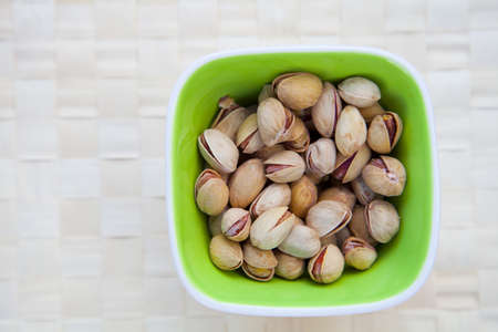 a bowl with pistachiosの写真素材