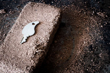 Growth concept with some soil and keysの写真素材