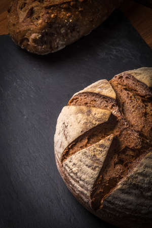 A Freshly baked organic bread on wooden table in Spainの写真素材