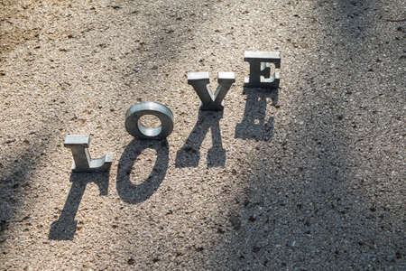 message of love with metal letters in a roadの写真素材