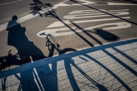 Street with traffic sign and bicycle shadow in Sant Cugat del Valles Barcelona Spainの写真素材
