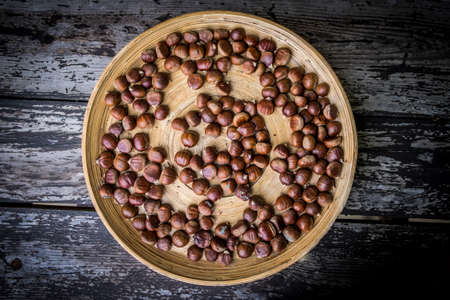 Hazelnuts on wood backgroundの写真素材