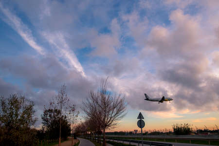 Barcelona, Spain - December 25, 2016: Plane is landing during a nice sunset in Spainのeditorial素材