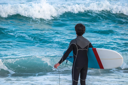 Barcelona, Spain - March 3, 2016: surfing in the popular beach of Barceloneta in the coast of the capital of Cataloniaのeditorial素材