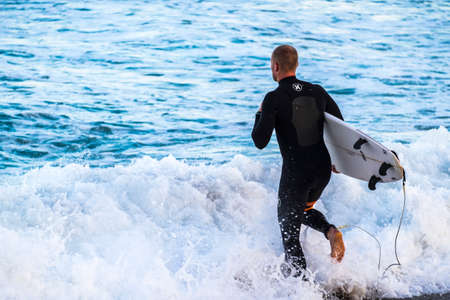 Barcelona, Spain - March 3, 2016: surfing in the popular beach of Barceloneta in the coast of the capital of Cataloniaのeditorial素材