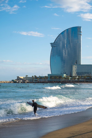 Barcelona, Spain - March 3, 2016: surfing in the popular beach of Barceloneta in the coast of the capital of Cataloniaのeditorial素材