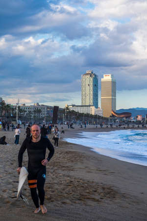 Barcelona, Spain - March 3, 2016: surfing in the popular beach of Barceloneta in the coast of the capital of Cataloniaのeditorial素材