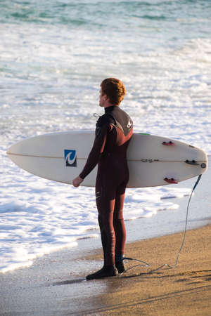 Barcelona, Spain - March 3, 2016: surfing in the popular beach of Barceloneta in the coast of the capital of Cataloniaのeditorial素材