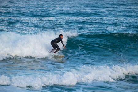 Barcelona, Spain - March 3, 2016: surfing in the popular beach of Barceloneta in the coast of the capital of Cataloniaのeditorial素材