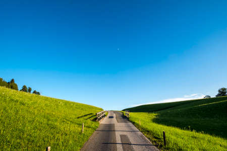 Rural road through a region of farms in the Austrian Alpsの写真素材