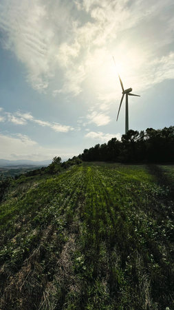 Wind turbines with the sky in the background in the agriculture fields in Lerida in Spain