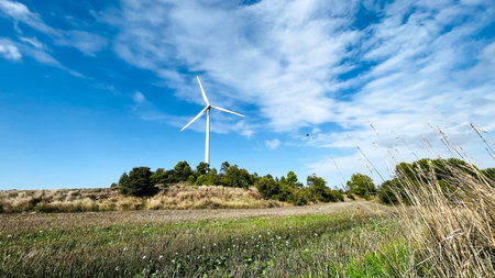 Wind turbines with the sky in the background in the agriculture fields in Lerida in Spain