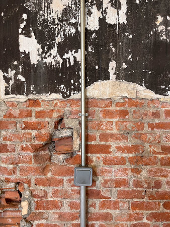 rustic wall with red bricks and weathered paintの写真素材