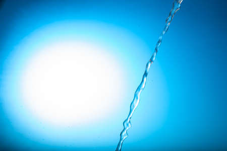 Water stream on a blue backgroundの写真素材