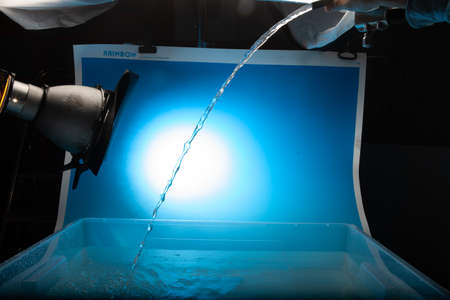 Water stream on a blue background.の写真素材