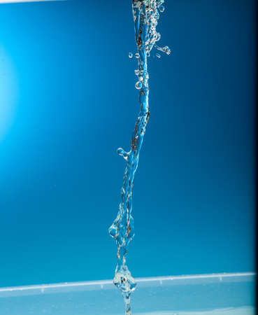 Water stream on a blue backgroundの写真素材