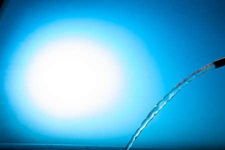 Water stream on a blue backgroundの写真素材