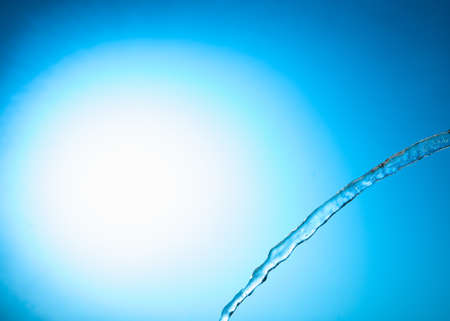 Water stream on a blue backgroundの写真素材