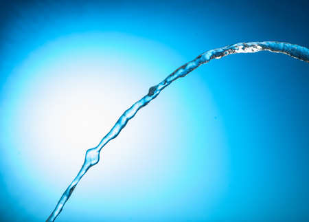 Water stream on a blue backgroundの写真素材