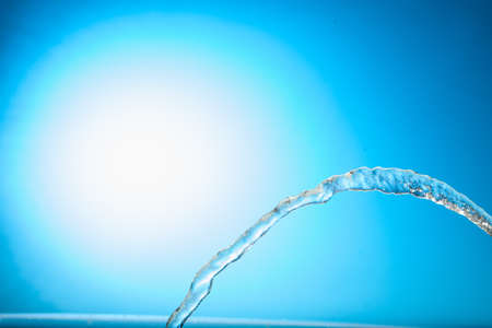 Water stream on a blue backgroundの写真素材