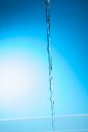Water stream on a blue backgroundの写真素材