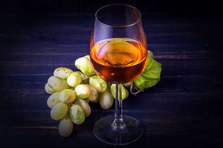 Glass of white wine and grapesの写真素材