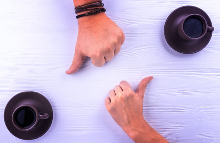 Two hands showing thumbs up for a coffee
