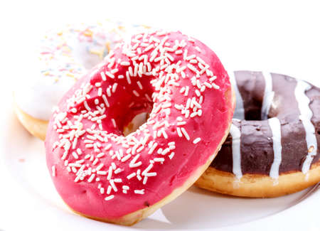 Delicious donuts with sprinkles on white backgroundの写真素材