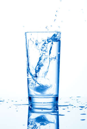 Water splash in glass of blue colorの写真素材