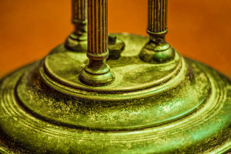 Antique rustic bronze decorative relief detail. Close up vintage metallic pillars on a circular pedestalの写真素材