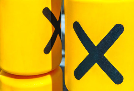Rotating plastic yellow cylinders with a play of tic-tac-toe for children entertainment