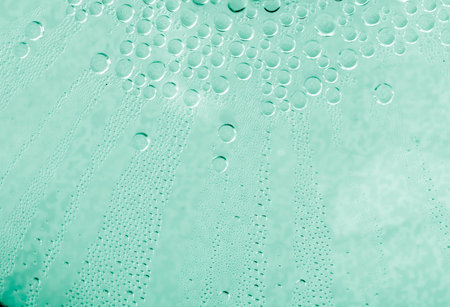 Water drops at gradient background. Glass covered with water drops condensation