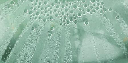 Water drops at gradient background. Glass covered with water drops condensation