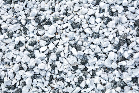 Small black and white pebble background. Top view of contrast gravel stone textureの写真素材