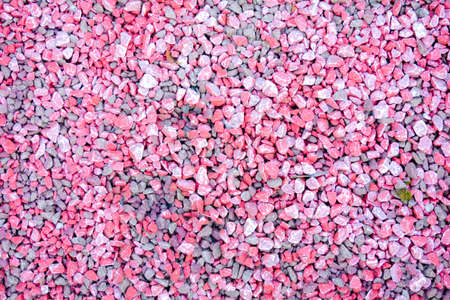 Small bright pink and grey pebble background. Top view of color gravel stone textureの写真素材