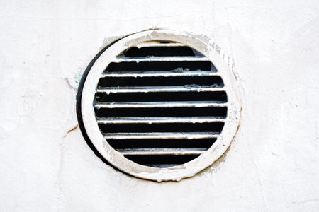 Metal industrial round air vent cover. Rust and dirty old round ventilation hole frame with...