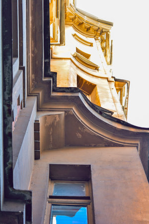 Bottom view of part of generic urban city classic style building exterior with decorative bay...