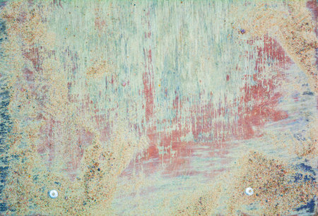 A worn old wood desk texture in the sand and mud as a background. The texture of the paint wooden...